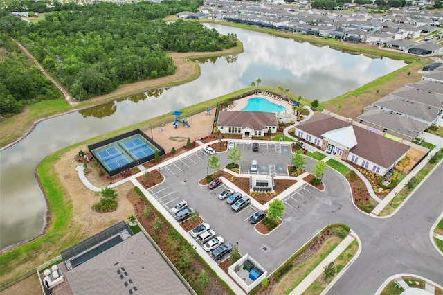 bird's eye view of a nearby body of water and a pool area