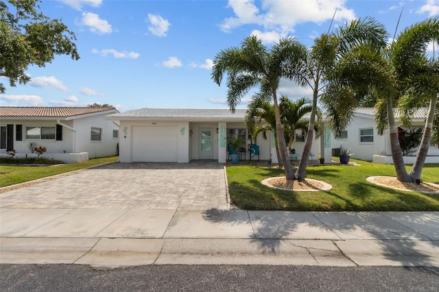9743 36th Way N Unit 4, Pinellas Park, FL 33782 - single story home with an attached garage, decorative driveway, a front yard, and stucco siding