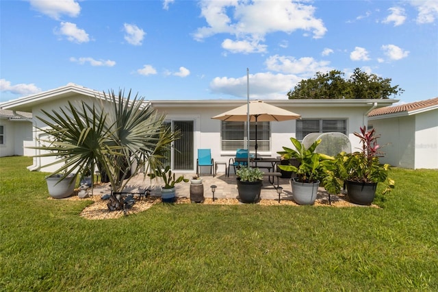 9743 36th Way N Unit 4, Pinellas Park, FL 33782 - back of house with a patio area, a yard, and stucco siding
