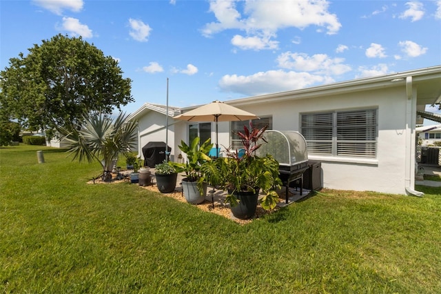 9743 36th Way N Unit 4, Pinellas Park, FL 33782 - rear view of property with a yard and stucco siding
