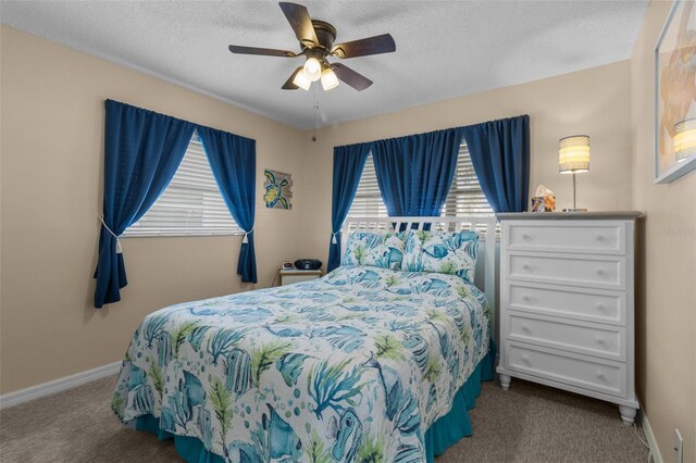 9743 36th Way N Unit 4, Pinellas Park, FL 33782 - carpeted bedroom featuring baseboards, a textured ceiling, and a ceiling fan