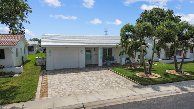 9743 36th Way N Unit 4, Pinellas Park, FL 33782 - ranch-style home with an attached garage, decorative driveway, a front yard, and a tile roof