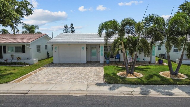 9743 36th Way N Unit 4, Pinellas Park, FL 33782 - ranch-style house featuring an attached garage, a front yard, a tile roof, and stucco siding
