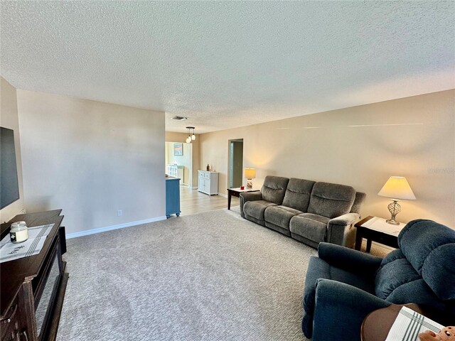 9743 36th Way N Unit 4, Pinellas Park, FL 33782 - living area featuring light carpet and a textured ceiling