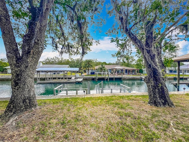 1011 SE 4th Ave, Crystal River, FL 34429 - view of swimming pool with a boat dock, boat lift, a water view, and a lawn