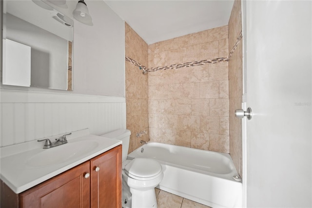 full bath with toilet, shower / bath combination, tile patterned floors, wainscoting, and vanity