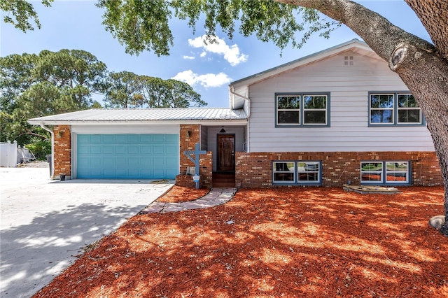 6515 Dimarco Rd, Tampa, FL 33634 - tri-level home featuring brick siding, a garage, and driveway