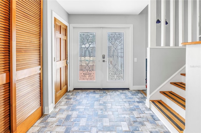 6515 Dimarco Rd, Tampa, FL 33634 - entryway with french doors, baseboards, and stairway