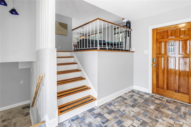 6515 Dimarco Rd, Tampa, FL 33634 - foyer with stone tile floors, baseboards, and stairway
