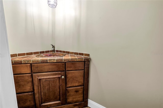 6515 Dimarco Rd, Tampa, FL 33634 - bathroom featuring a sink and baseboards