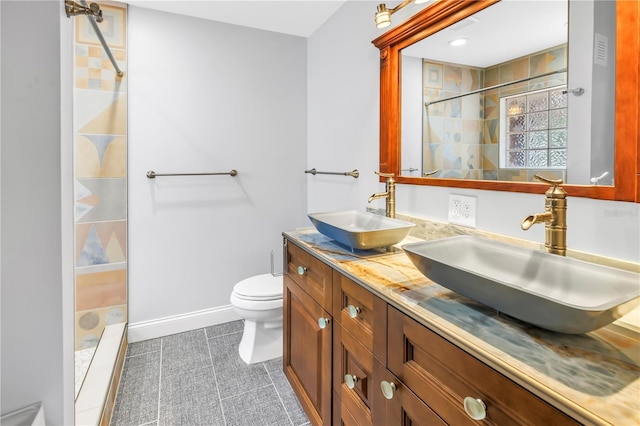 6515 Dimarco Rd, Tampa, FL 33634 - full bath with tiled shower, toilet, tile patterned floors, double vanity, and baseboards