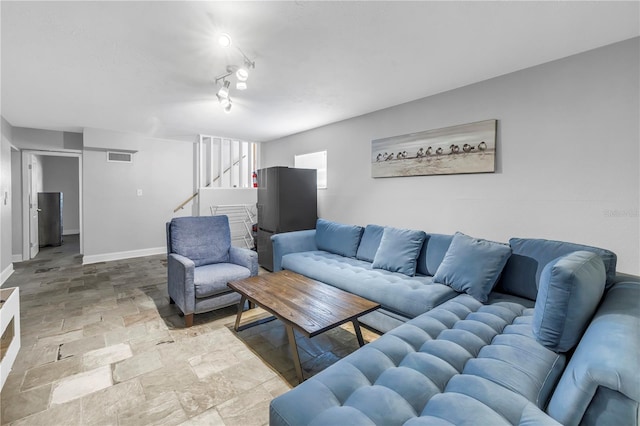 6515 Dimarco Rd, Tampa, FL 33634 - living area featuring light stone finish floors, baseboards, and stairs