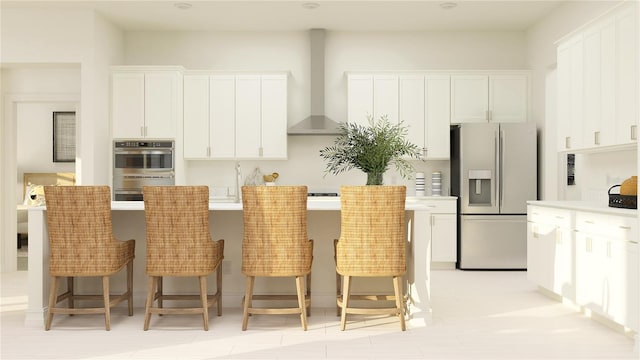 6837 E 115th St, Palmetto, FL 34221 - kitchen featuring white cabinetry, wall chimney range hood, a kitchen island with sink, and appliances with stainless steel finishes