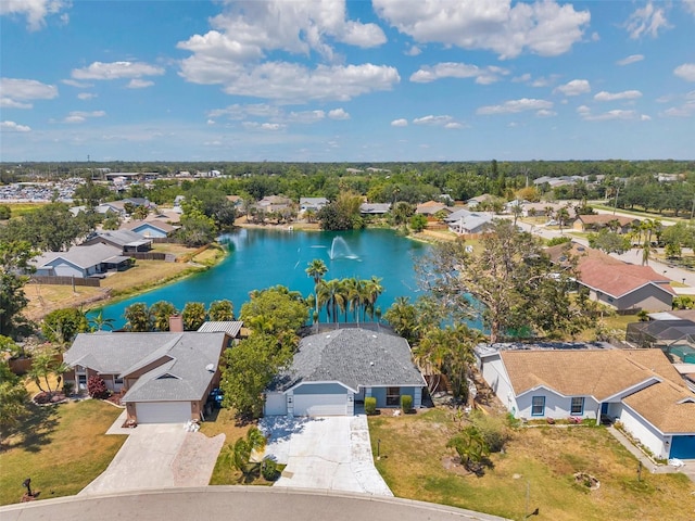 drone / aerial view with a water view and a residential view