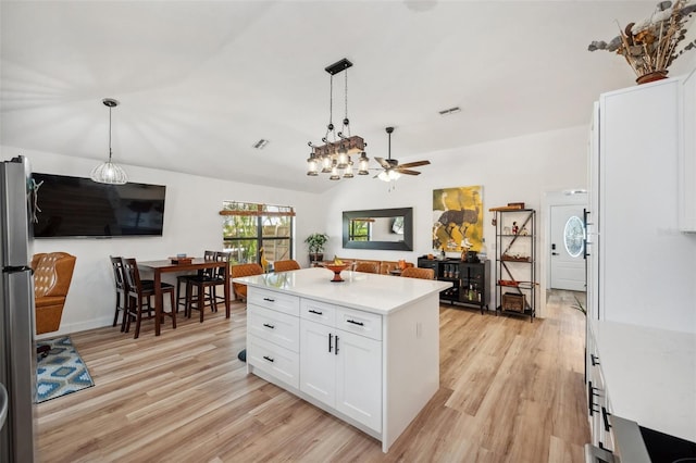 kitchen with light countertops, light wood-style flooring, and ceiling fan