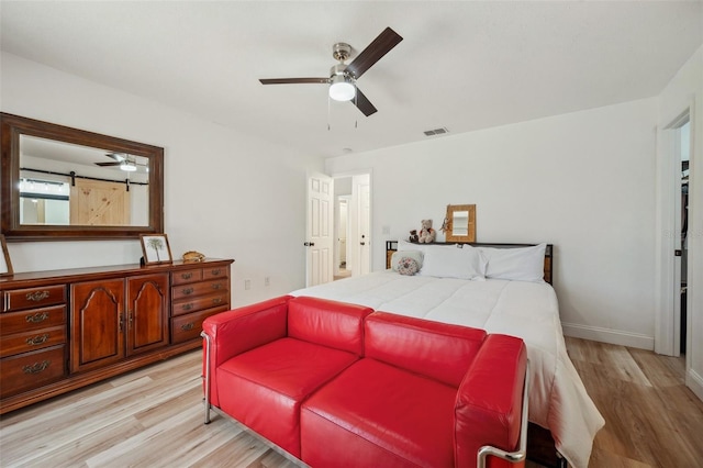 bedroom with light wood-style flooring, baseboards, a ceiling fan, and visible vents