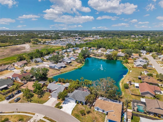 birds eye view of property with a water view and a residential view