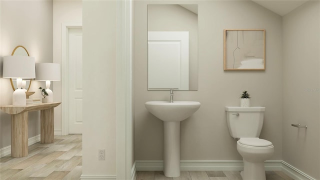 6909 E 116th Ct, Palmetto, FL 34221 - bathroom featuring toilet, baseboards, and wood finished floors