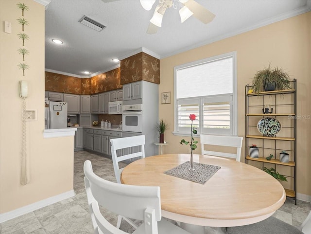 dining area featuring baseboards, ceiling fan, ornamental molding, and recessed lighting