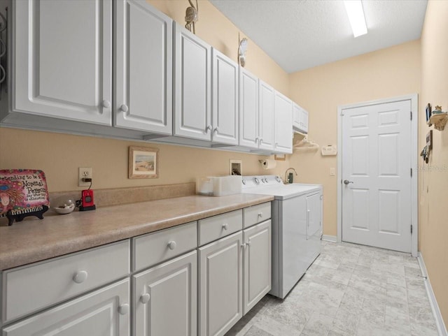 laundry room featuring cabinet space, washing machine and dryer, and baseboards