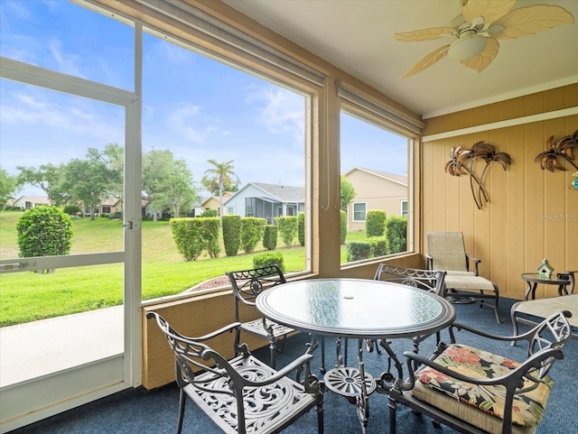 sunroom featuring a ceiling fan