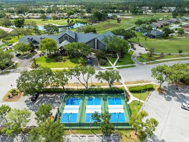 aerial view of residential area featuring a large body of water and a local golf course