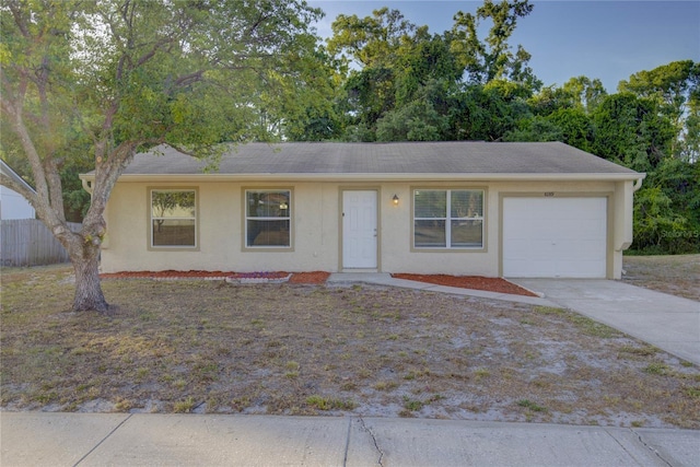 10319 Widgeon Way, New Port Richey, FL 34654 - single story home with stucco siding, a garage, and driveway