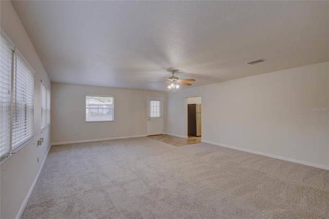10319 Widgeon Way, New Port Richey, FL 34654 - empty room with ceiling fan, light colored carpet, baseboards, and a textured ceiling