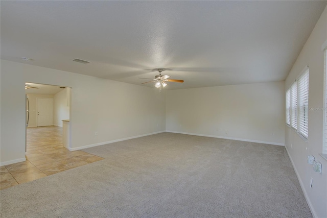 10319 Widgeon Way, New Port Richey, FL 34654 - empty room with a ceiling fan, light carpet, and baseboards