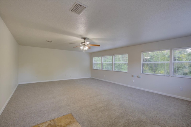 10319 Widgeon Way, New Port Richey, FL 34654 - empty room featuring light colored carpet, a ceiling fan, a textured ceiling, and baseboards