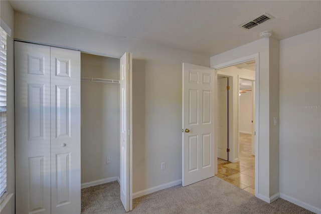 10319 Widgeon Way, New Port Richey, FL 34654 - unfurnished bedroom with light carpet, a closet, and baseboards