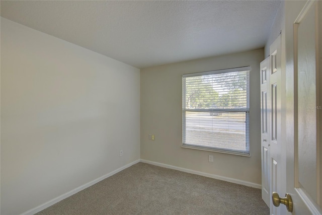 10319 Widgeon Way, New Port Richey, FL 34654 - spare room featuring a textured ceiling, carpet, and baseboards