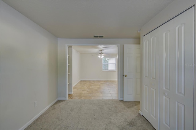 10319 Widgeon Way, New Port Richey, FL 34654 - hallway featuring carpet floors, baseboards, and tile patterned flooring