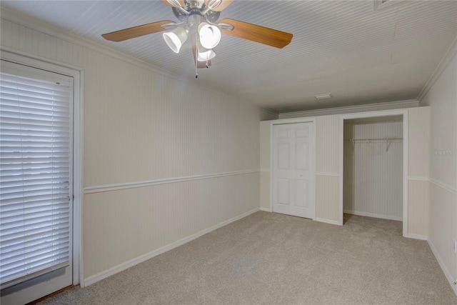10319 Widgeon Way, New Port Richey, FL 34654 - unfurnished bedroom featuring a closet, carpet flooring, a ceiling fan, and crown molding