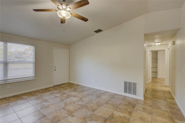 10319 Widgeon Way, New Port Richey, FL 34654 - unfurnished room featuring lofted ceiling, ceiling fan, and baseboards