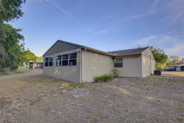 10319 Widgeon Way, New Port Richey, FL 34654 - view of side of property with cooling unit and stucco siding