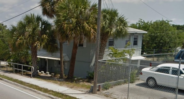 view of side of home with fence