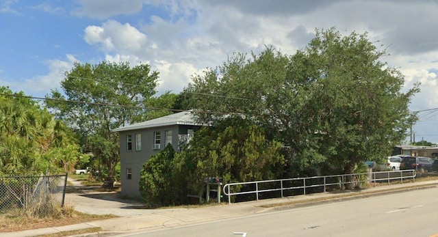 view of asphalt road with sidewalks and curbs