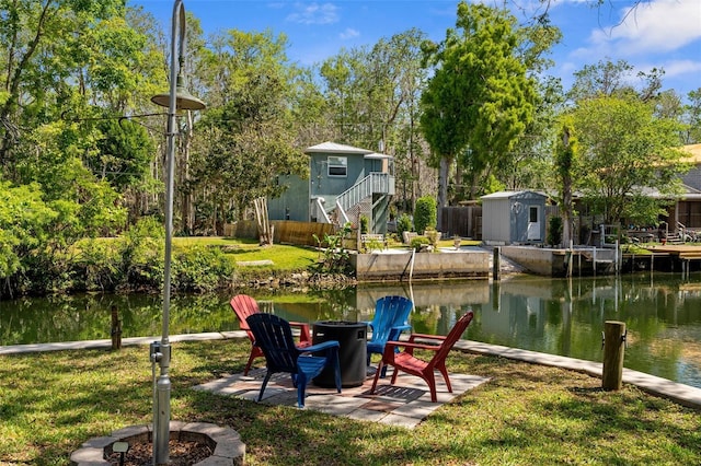 5421 Gay St, Weeki Wachee, FL 34607 - dock area featuring fence, a fire pit, a yard, stairway, and a water view