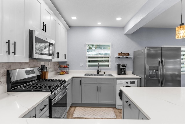 5421 Gay St, Weeki Wachee, FL 34607 - kitchen featuring a sink, white cabinets, washer / dryer, appliances with stainless steel finishes, and recessed lighting