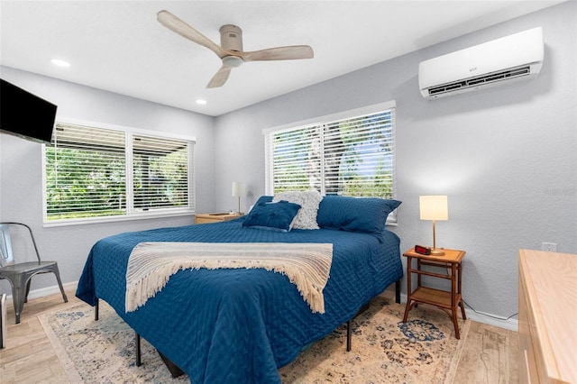 5421 Gay St, Weeki Wachee, FL 34607 - bedroom featuring multiple windows, wood finished floors, and a wall unit AC