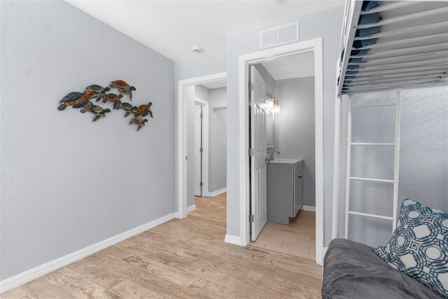 5421 Gay St, Weeki Wachee, FL 34607 - corridor with baseboards, light wood-style flooring, and visible vents