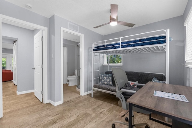 5421 Gay St, Weeki Wachee, FL 34607 - bedroom featuring wood finished floors, visible vents, ceiling fan, connected bathroom, and baseboards
