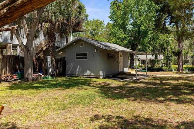 5421 Gay St, Weeki Wachee, FL 34607 - rear view of property featuring a yard, fence, and an outbuilding