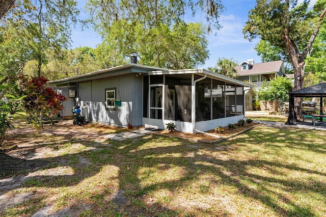 5421 Gay St, Weeki Wachee, FL 34607 - rear view of house with a sunroom, a yard, and a gazebo