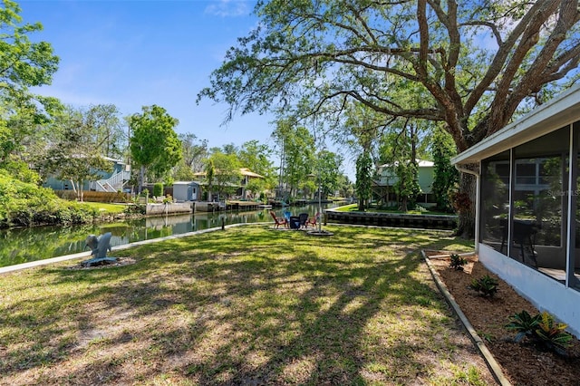 5421 Gay St, Weeki Wachee, FL 34607 - view of yard featuring a sunroom and a water view