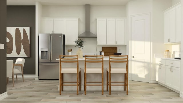 6905 E 116th Ct, Palmetto, FL 34221 - kitchen featuring light wood finished floors, a center island, stainless steel refrigerator with ice dispenser, white cabinetry, and wall chimney range hood