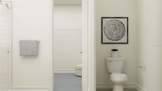 6905 E 116th Ct, Palmetto, FL 34221 - bathroom with toilet, baseboards, and tiled shower