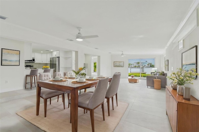 dining space featuring ceiling fan and light tile patterned floors