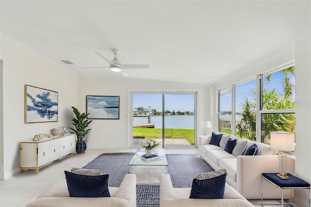 living room with healthy amount of natural light, baseboards, and a water view